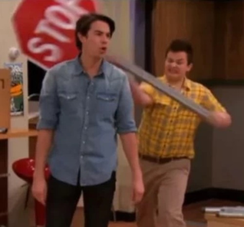 Gibby hitting Spencer with a stop sign meme template